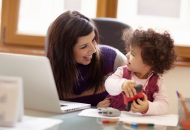 woman with laptop and child